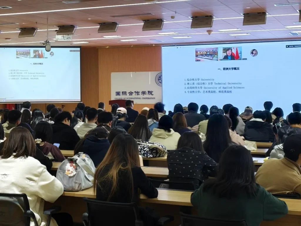 Students attending a talk in a lecture hall, seen from behind