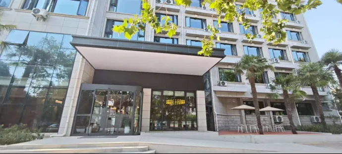 The glass-fronted entrance of the hotel on campus