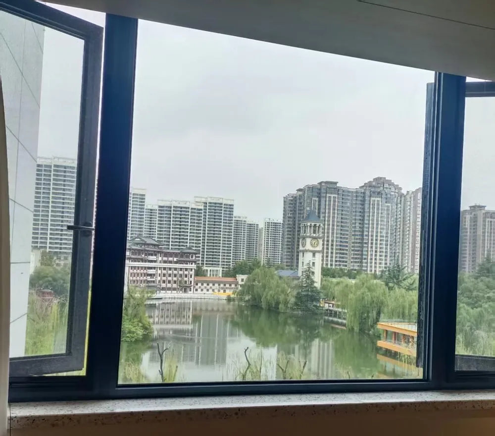 The campus lake and a clock tower, seen from a hotel window