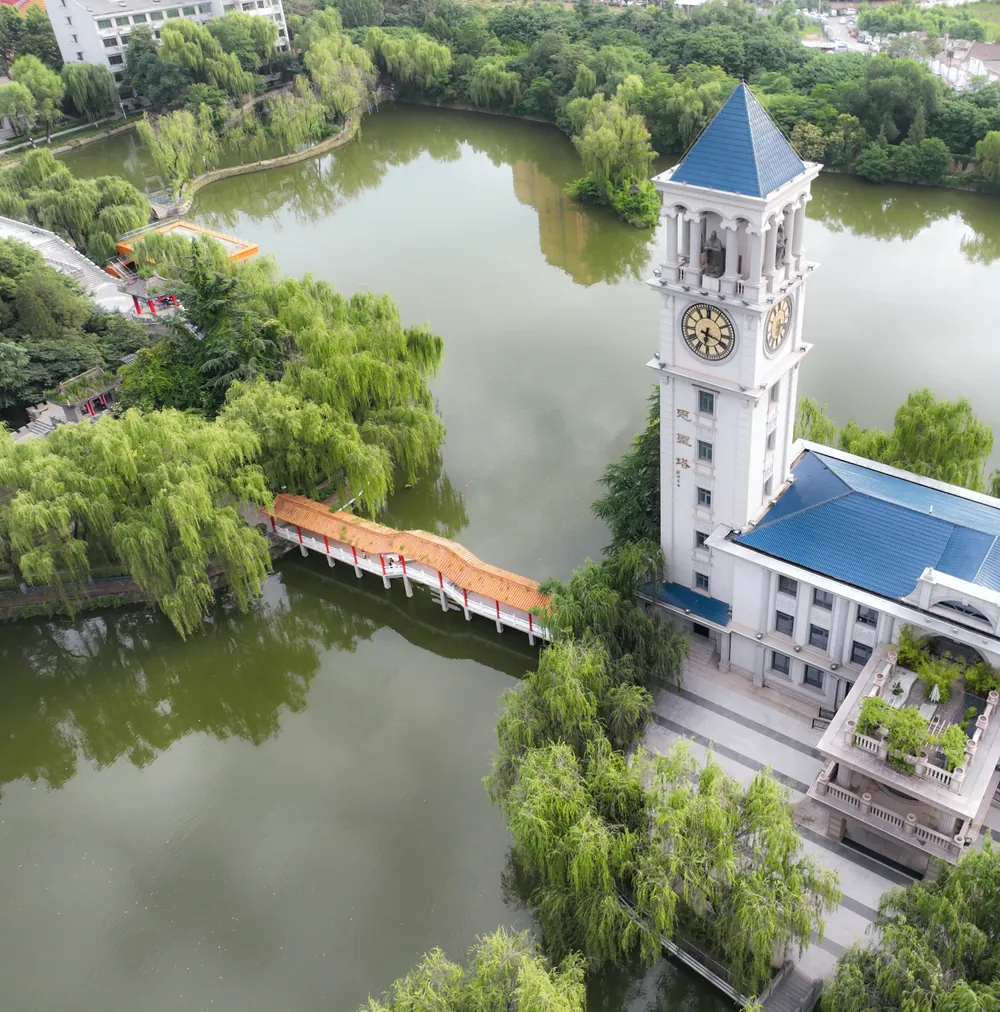 Aerial view of the campus lake, clock tower and covered bridge