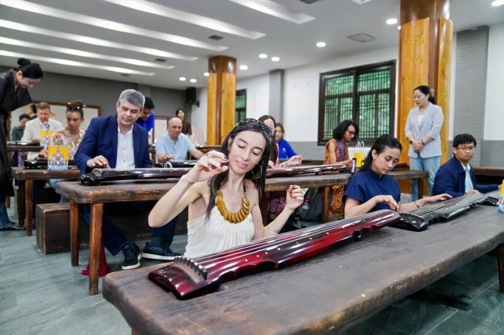 Students at their instruments during a guqin class