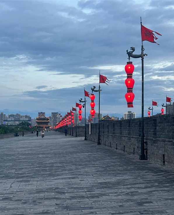 The walkway on top of the city wall, hung with red lanterns